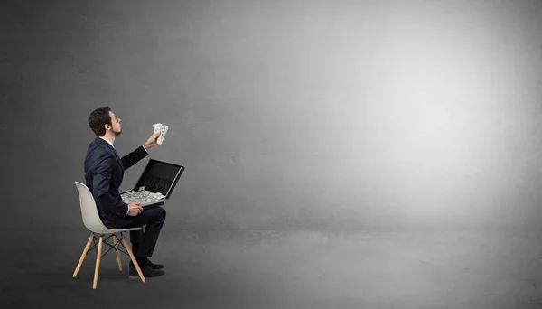 Businessman staying in an empty room with stuffs on his lap — Stock Photo, Image