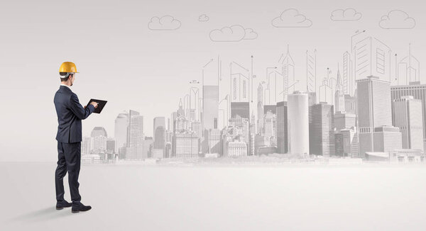 Architect standing and  replanning a city panorama