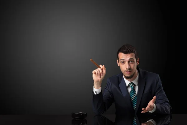 Businessman holding cigarette. — Stock Photo, Image