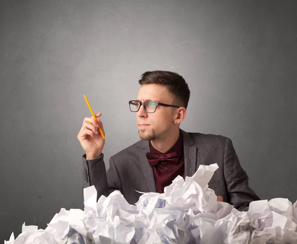 Businessman behind crumpled paper