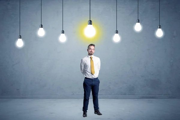 Businessman standing uninspired with bulbs above — Stock Photo, Image