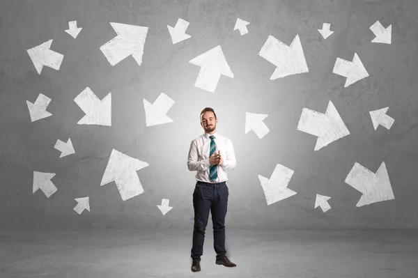 Businessman standing with arrows around — Stock Photo, Image