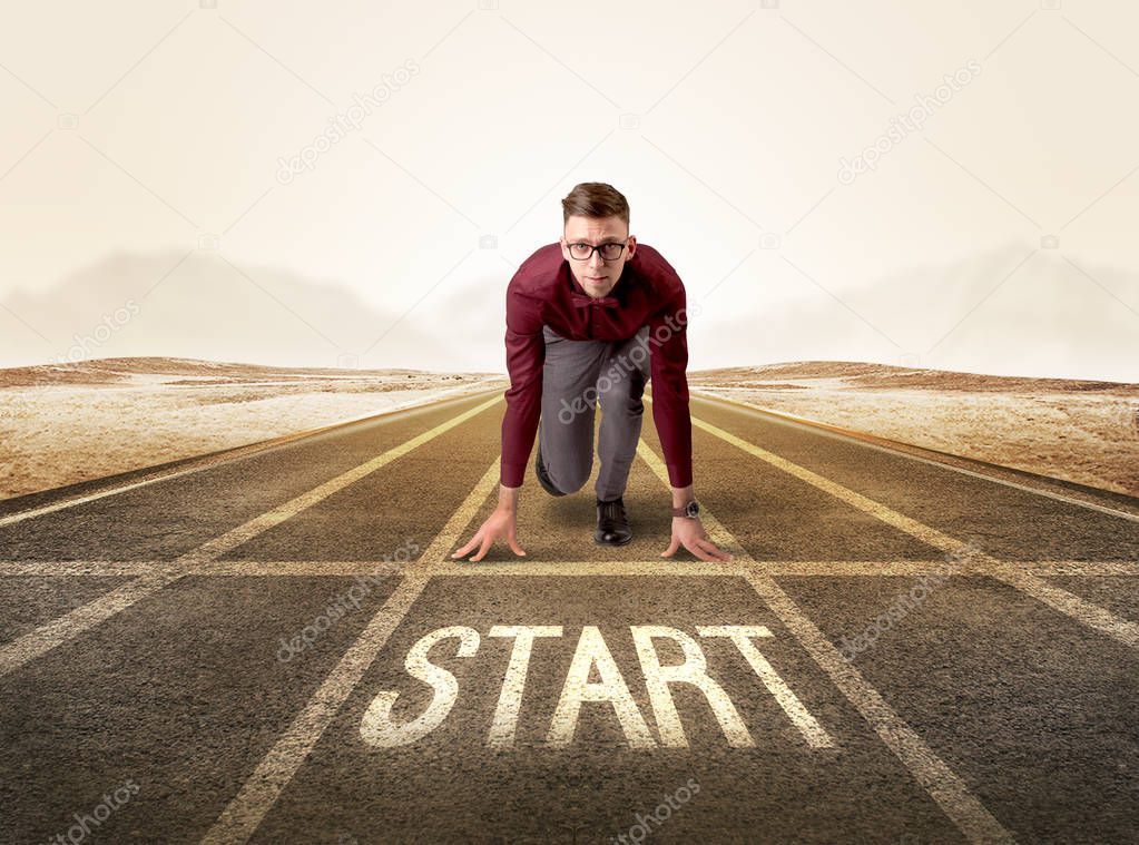 Businessman kneeling in ready position