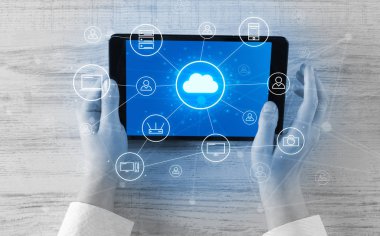 Hand using tablet with centralized cloud computing system concept clipart