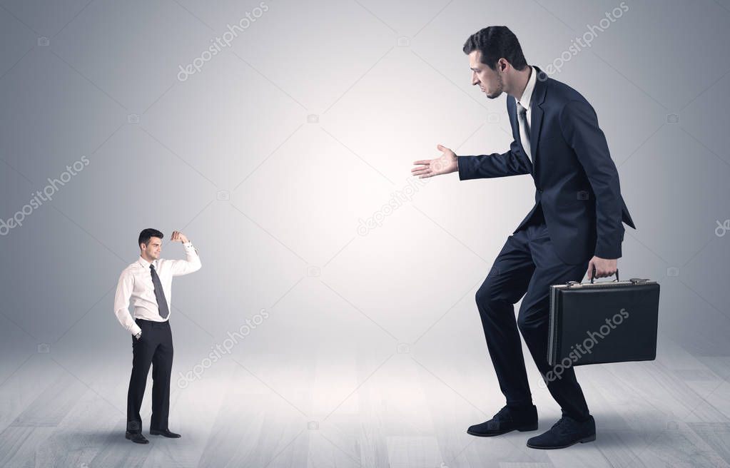 Giant businessman scared of small businessman