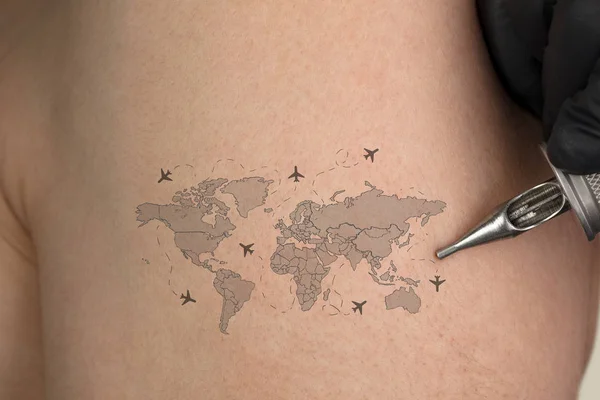 Tattooing traveling concept on naked back