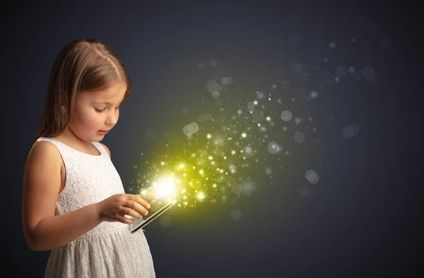 Little kid playing on sparkling tablet — Stock Photo, Image