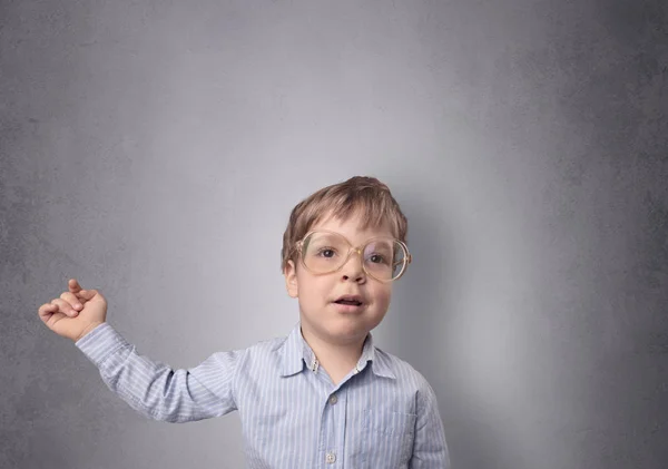 Adorable little boy in front of an empty wall — Stock Photo, Image
