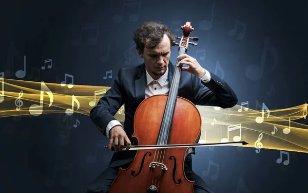 Musicien jouant sur violoncelle avec des notes autour — Photo