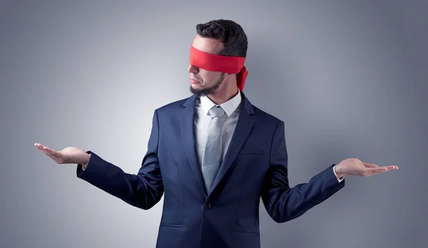 Covered eye businessman in front of a wall — Stock Photo, Image