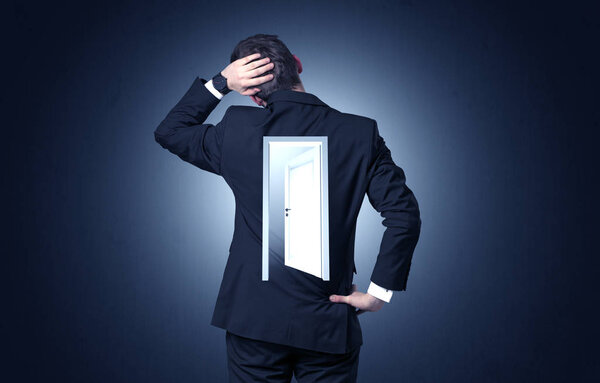 Businessman standing with door on his back