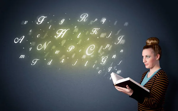 Young lady holding book with letters — Stock Photo, Image