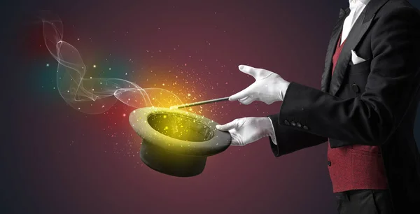 Illusionist hand making trick with wand — Stock Photo, Image