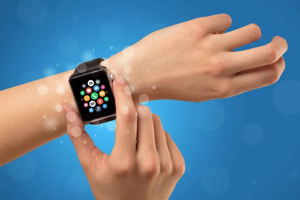 Female hand with smartwatch and app icons — Stock Photo, Image