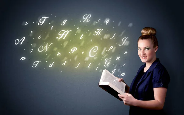 Young lady holding book with letters — Stock Photo, Image