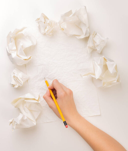 Writing hand in crumpled paper