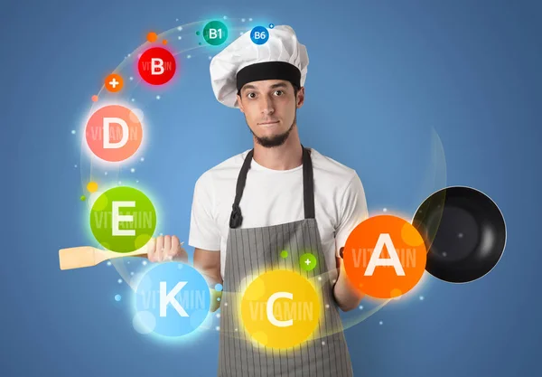 Handsome cook with vitamin concept — Stock Photo, Image