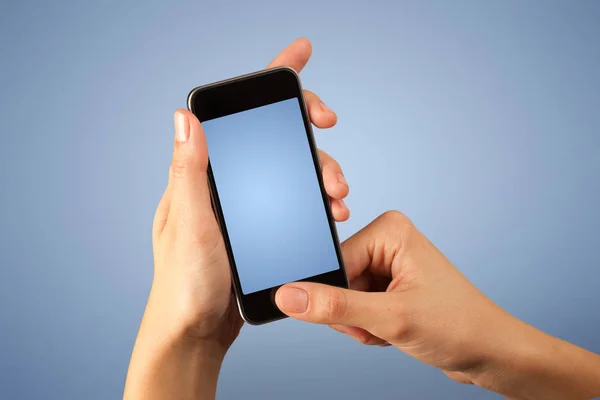 Female hand holding smartphone — Stock Photo, Image