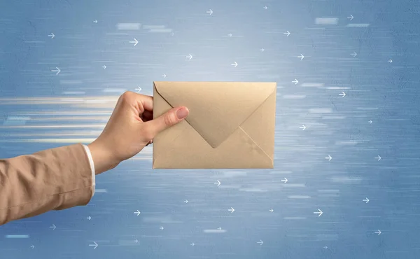Hand holding envelope with arrows around — Stock Photo, Image