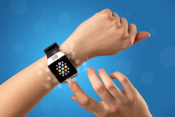 Female hand with smartwatch and app icons — Stock Photo, Image