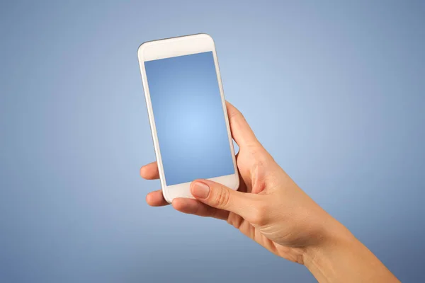 Female hand holding smartphone — Stock Photo, Image