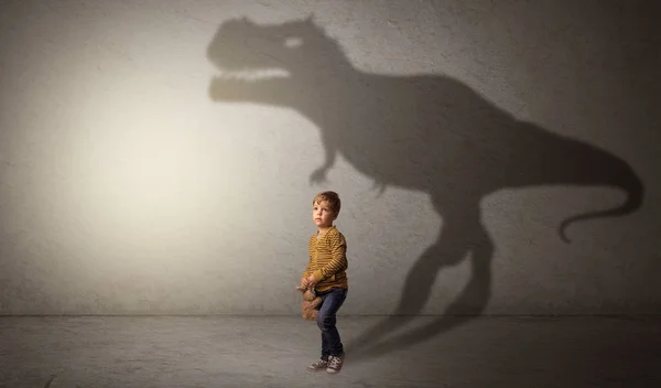 Dinosaurus shadow behind cute boy — Stock Photo, Image