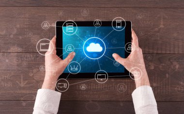 Hand using tablet with centralized cloud computing system concept clipart