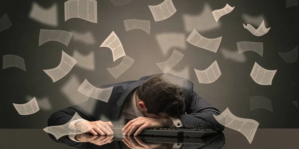 Businessman fell asleep at the office with paperwork concept