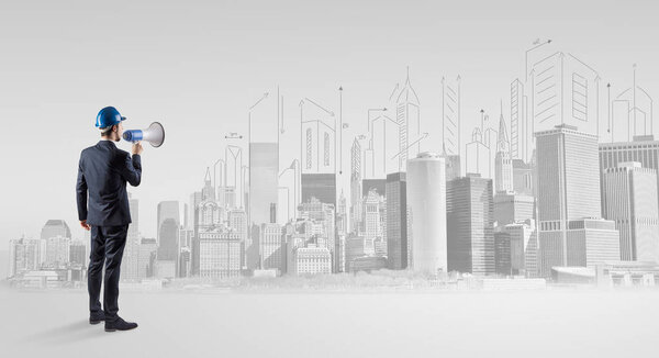 Architect standing and  replanning a city panorama