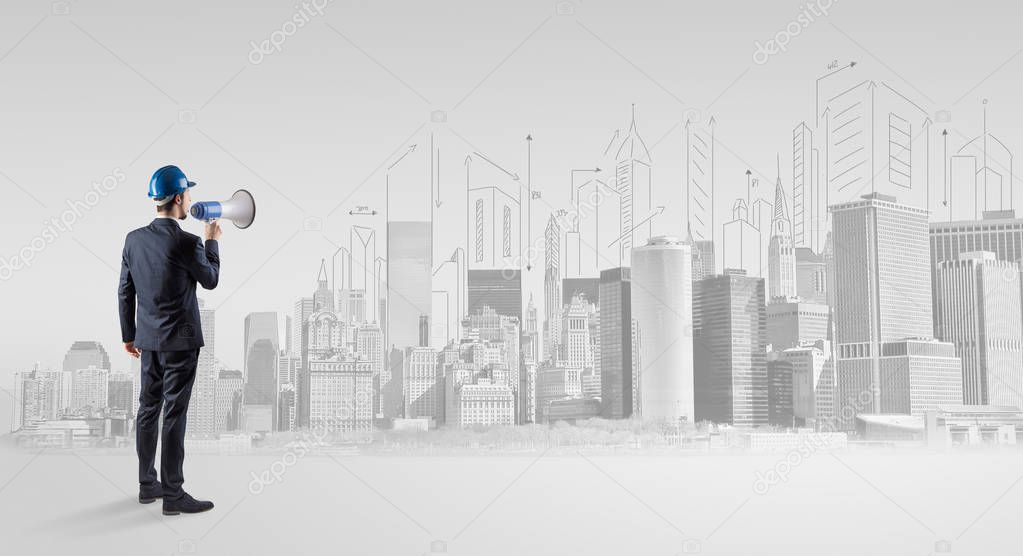 Architect standing and  replanning a city panorama