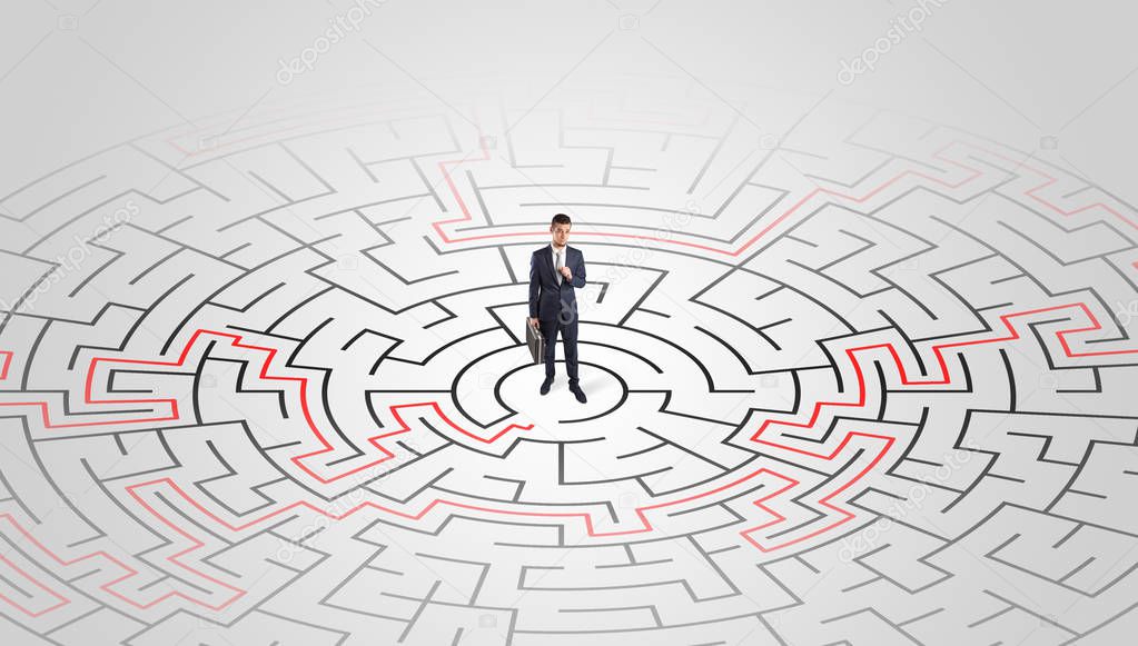 Young entrepreneur standing in a middle of a labyrinth 