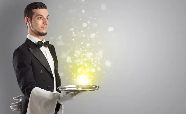 Waiter serving mysterious light on tray — Stock Photo, Image