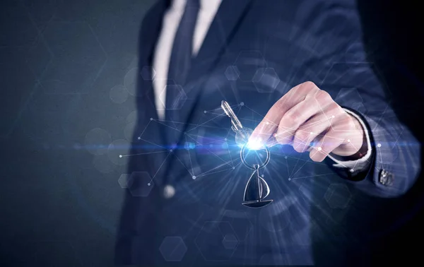 Man holding keys with connection concept — Stock Photo, Image