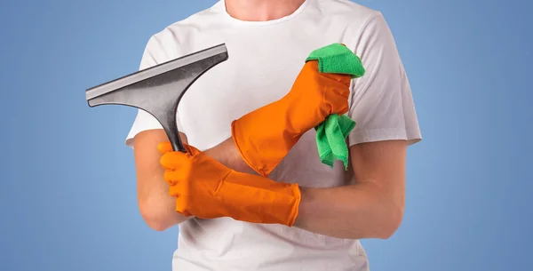 Housekeeper in front of a blue empty wall — Stock Photo, Image