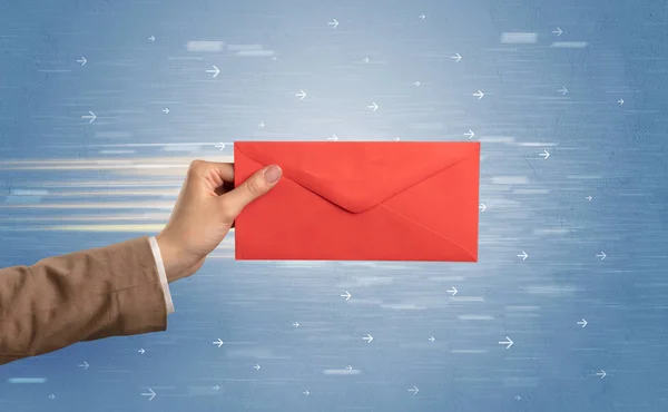 Hand holding envelope with arrows around — Stock Photo, Image