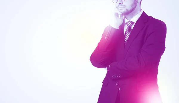 Young businessman standing and thinking — Stock Photo, Image