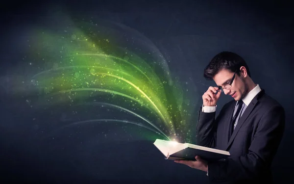 Young man holding book with wave — Stock Photo, Image