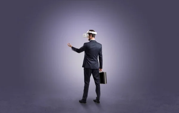 Businessman in an empty room with vr glasses — Stock Photo, Image