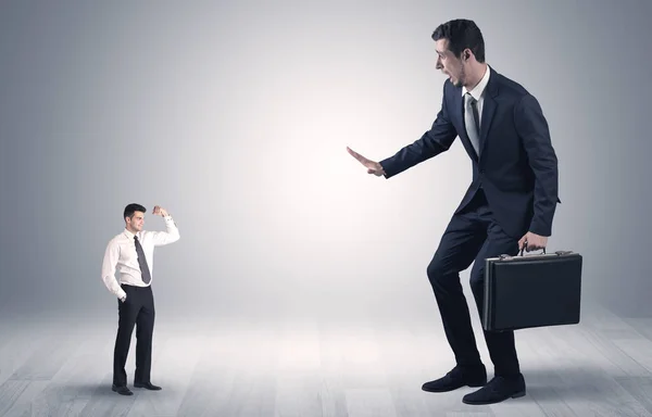 Giant businessman scared of small businessman — Stock Photo, Image