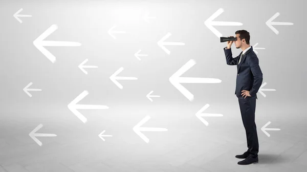 Man looking with binoculars and arrows around — Stock Photo, Image