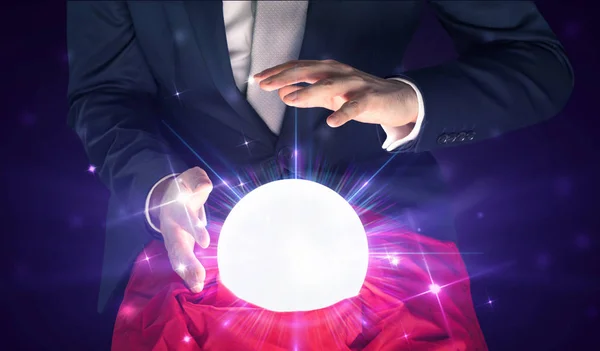 Businessman sitting with crystal ball in action — Stock Photo, Image