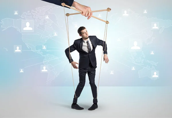 Little businessman controlled from above by another big hand — Stock Photo, Image
