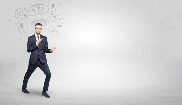 Businessman fighting with doodled symbols concept — Stock Photo, Image