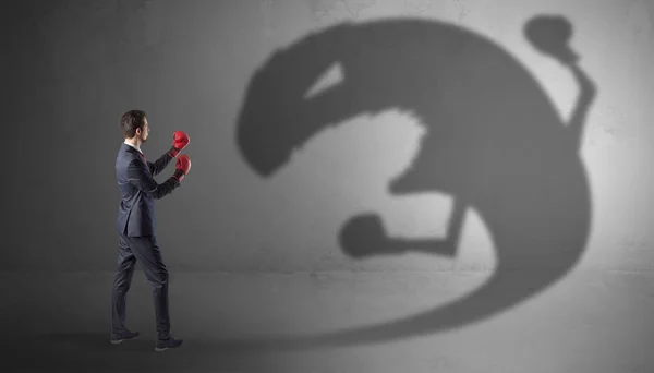 Empresário lutando com uma grande sombra monstro — Fotografia de Stock