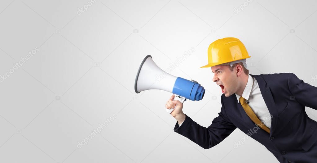 Young architect yelling with megaphone 