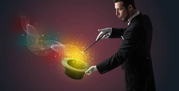 Illusionist hand making trick with wand — Stock Photo, Image