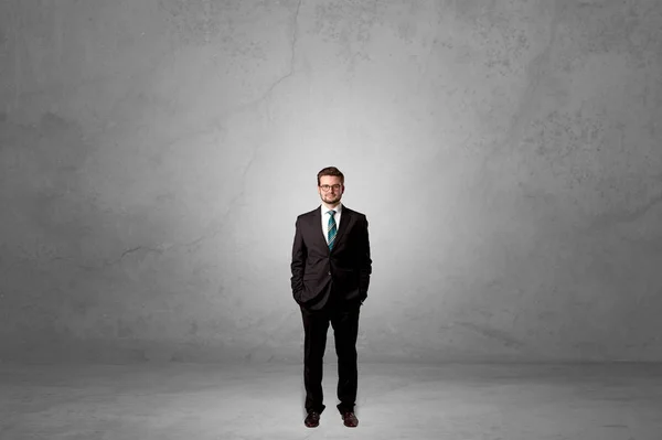 Alone businessman standing in a dark room — Stock Photo, Image