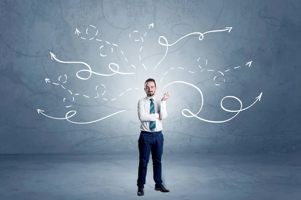 Businessman standing with winding arrows around — Stock Photo, Image