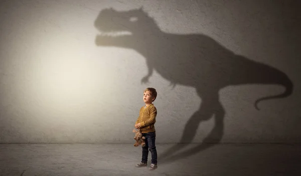 Dinosaurus shadow behind cute boy — Stock Photo, Image