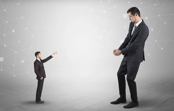 Small man aiming at a big man with network concept — Stock Photo, Image